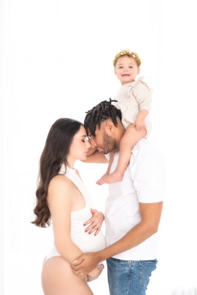 pregnant mother with father and child during maternity photoshoot 