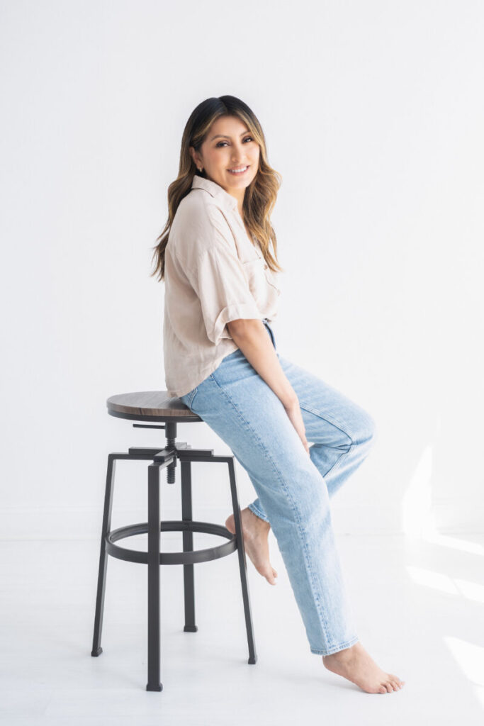 woman sitting in stool posing for personal branding session 